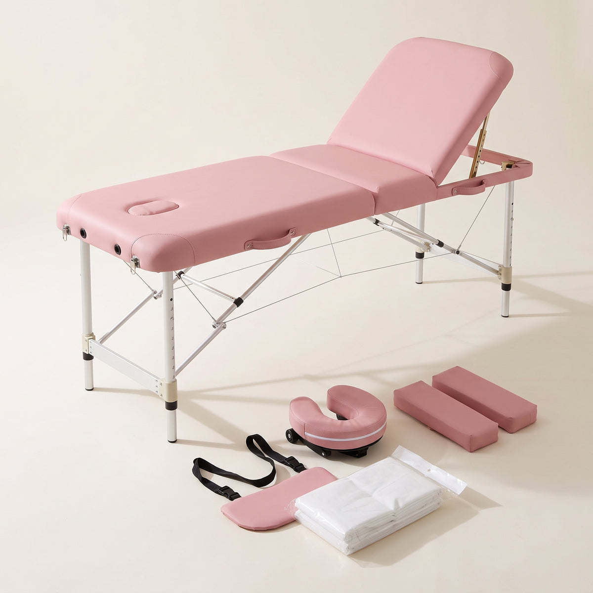 Table de massage pliante PIKKO rose avec ses accessoires : têtière, repose-bras et 30 housses jetables