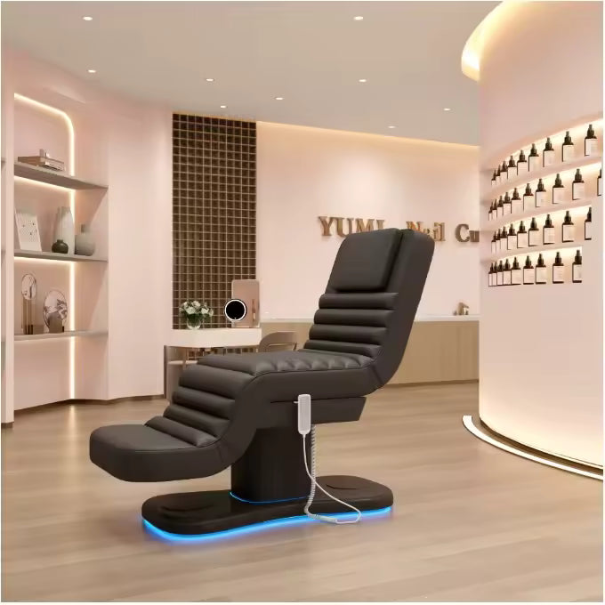 Table de massage électrique VIRTO noire à éclairage LED bleu installée dans un institut de beauté