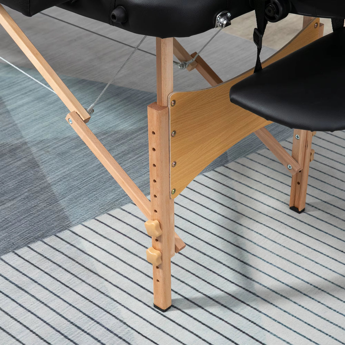 Pied en bois de hêtre réglable et câbles tenseurs de la table de massage pliante SKORTA